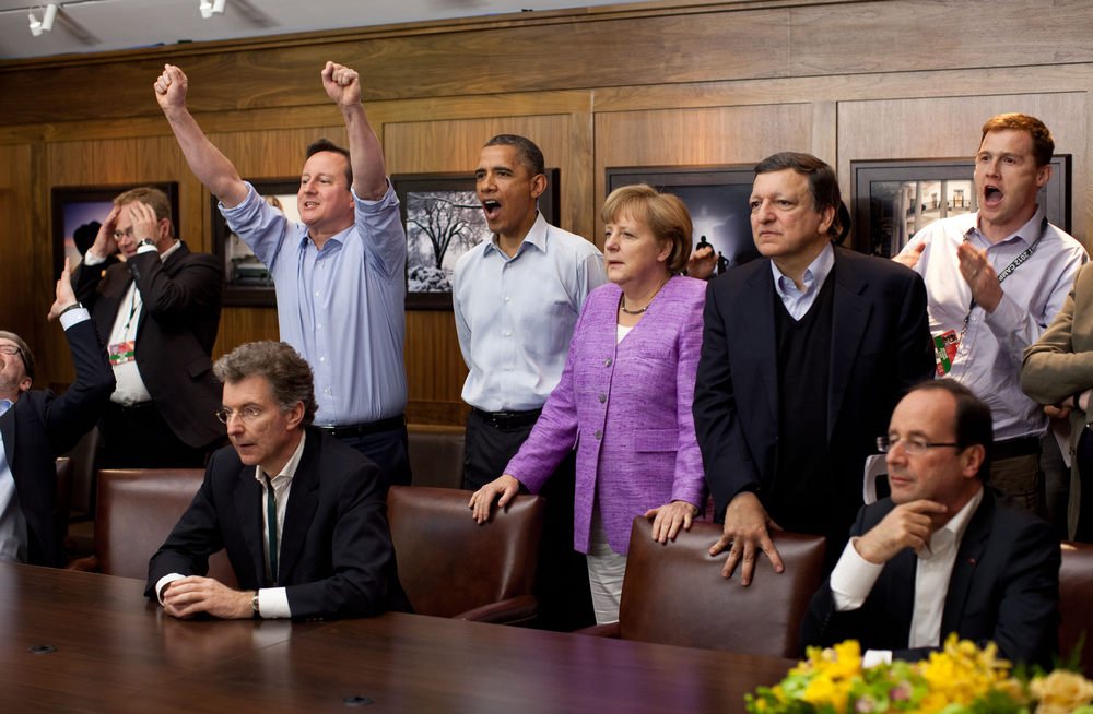 Prime Minister David Cameron of the United Kingdom, President Barack Obama, Chancellor Angela Merkel of Germany, Jos Manuel Barroso, President of the European Commission, and others watch the overtime shootout of the Chelsea vs. Bayern Munich Champions League final in the Laurel Cabin conference room during the G8 Summit at Camp David, Md., May 19, 2012. (Official White House Photo by Pete Souza) This official White House photograph is being made available only for publication by news organizations and/or for personal use printing by the subject(s) of the photograph. The photograph may not be manipulated in any way and may not be used in commercial or political materials, advertisements, emails, products, promotions that in any way suggests approval or endorsement of the President, the First Family, or the White House.